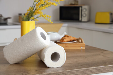 Rolls of paper towels on table in kitchen, closeup