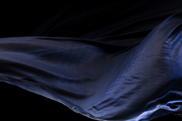 Blue silver shinny fabric flying in curve shape, Piece of textile blue silvery fabric throw fall in...