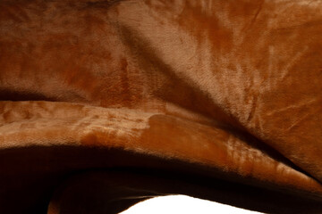 Brown fur wool fabric flying in curve shape, Piece of textile Brown fur wool fabric throw fall in air. White background isolated, dark shading environment