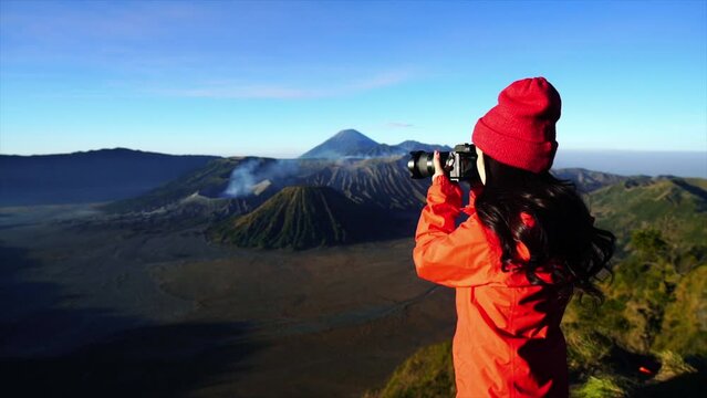 Tourist taking photo at Mount Bromo volcano (Gunung Bromo) in Bromo Tengger Semeru National Park, East Java, Indonesia.