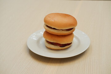 Hamburger bun on a white plate. Close up.