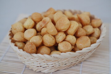 a traditional cake from Indonesia called kue sus filled with cream puffs