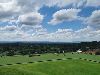green grass course with clouds
