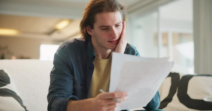 Home, man and student document on sofa with exam stress, anxiety and worry with learning. Thinking, reading and paperwork for college, education and school test with studying in a living room