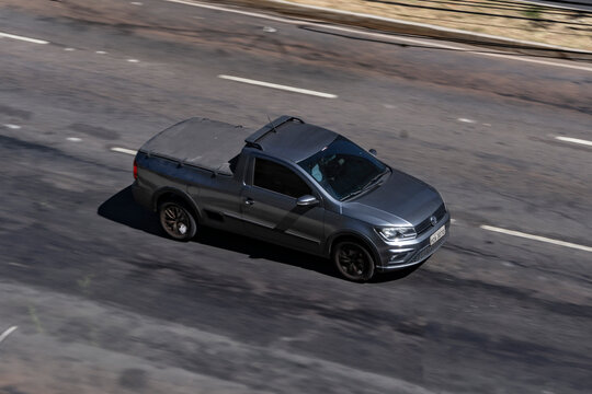 Panning shot of a grey Volkswagen Pick-up Truck, Saveiro in city street