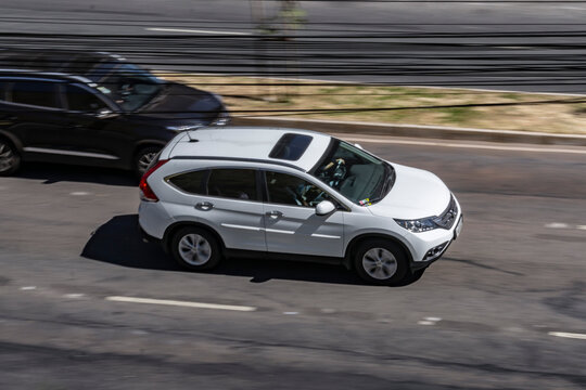 White Honda CR-V panning shot in city street, japanese SUV, 7 seater - High Resolution Image