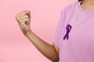Hand Clenching Fist Showing Win Gesture Wearing Purple Ribbon For Support People Suffering Alzheimer's, Epilepsy And Lupus. World Cancer Day