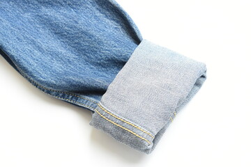 roll up sleeve of blue denim shirt texture isolated on white background, jean fashion style
