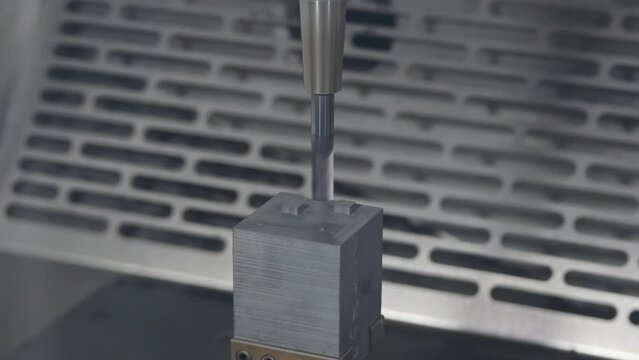 The CNC milling machine rough cutting the graphite electrode parts by flat end mill tool.