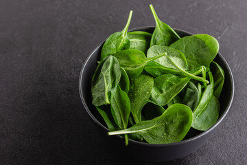 Fresh green spinach leaves in the bowl. Natural vegetarian food.