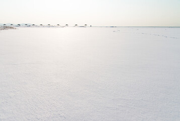 snow-covered seaside with the parasol