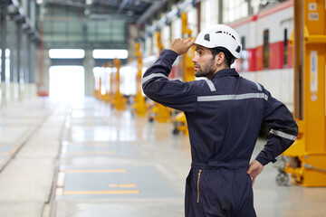 Back view technician or worker looking to something at construction train station