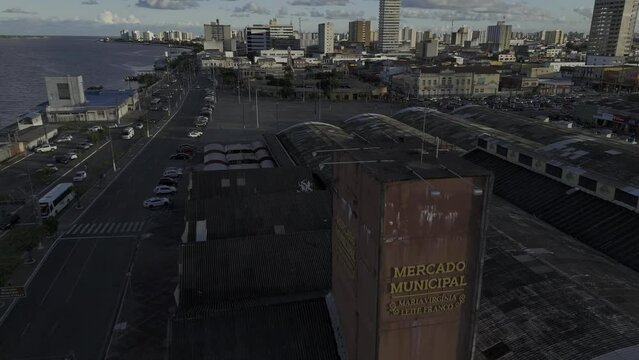 Drone flies low over Mercado Municipal Maria Virg&iacute;nia Leite Franco toward Mercado Municipal Ant&ocirc;nio Franco at sunset