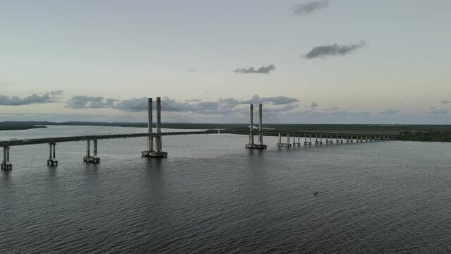 Drone rises in front of Aracaju-Barra dos Coqueiros bridge crossing the Sergipe River at sunset