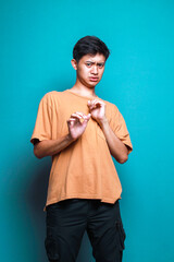 Fototapeta premium Young Asian man feeling afraid isolated over blue background