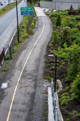 View from above of Mountains to Sound Greenway trail at Eastgate next to the highway, I90, cement urban recreation trail at a switchback turn with benches for rest
