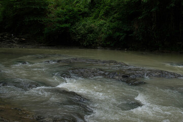 the calm flow of river water in a village 