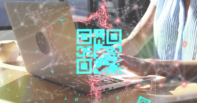 Young Caucasian woman typing on laptop with QR code and digital network overlay - Powered by Adobe