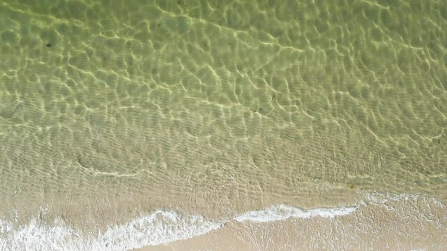 Crystal Clear Ocean Water With Waves Running Ashore In Dennis Port, Nantucket Sound, Massachusetts. aerial topdown shot
