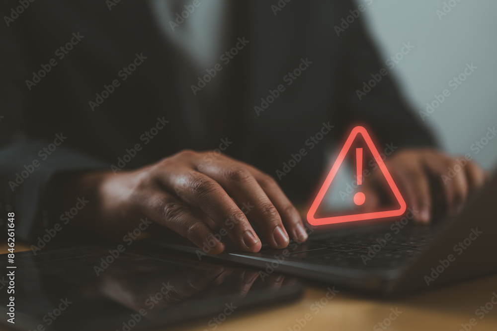 Poster Businessman or it staff, programmer, developer using computer laptop with triangle caution warning sign for notification error and maintenance concept.