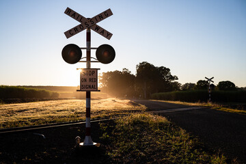 Cane train rail railway crossing, rural Queensland Australia, early morning sunrise dawn, sugarcane...