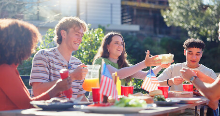 Friends, group and eating bbq in garden on terrace with conversation, holiday or social event in...