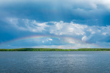 Rainbow over Blue lake with cloudy sky