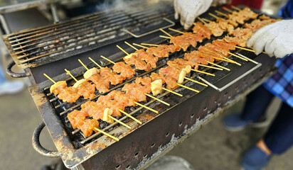 Thai-Style Grilled Pork Skewers (Moo Ping). Grilled pork skewers marinated with sweet soy sauce. Thai-style grilled pork skewers are slightly sweet cooking on charcoal grills. Thai street food