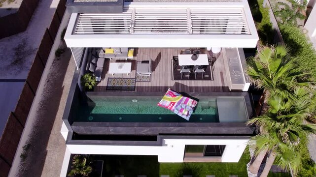 Aerial shot of a lilo floating on a balcony private pool at a villa in Sete