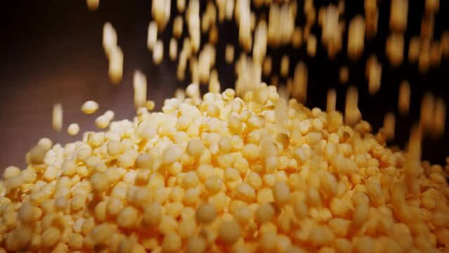 Production of puffed corn cereal balls on industrial food processing line.