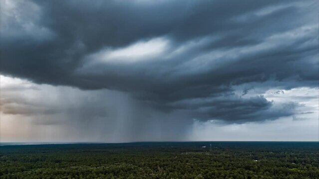 Aerial time lapse rain storm over forest 