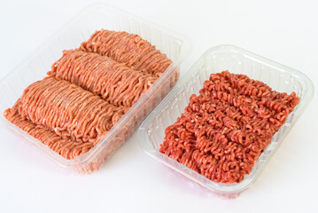 Ground beef and pork - comparison by color. in store-bought plastic packaging. Close-up, texture