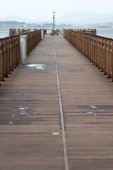 Obraz premium View of the footpath on the wooden bridge at the seaside