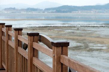 View of the fence on the wooden bridge at the seaside