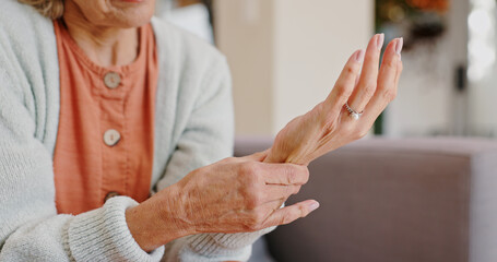 Medical, wrist pain and senior person with arthritis, osteoporosis and fibromyalgia on sofa. Home,...