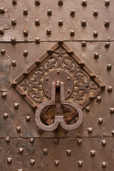 Door knocker on a exterior building door of a historic building in Genova