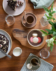 wooden table with tea and macarons