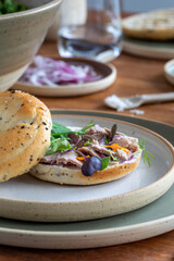 Tuna bagel with salad and red onion