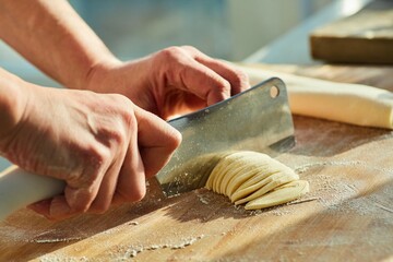 Step-by-step cooking process. Cut the dough into small strips. Making homemade noodles or pasta.