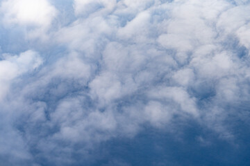 Clouds photographed from an airplane，Cumulus clouds are clouds that have flat bases and are often...