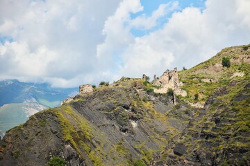 The ruins of an ancient tower on the top of the mountain. The Caucasus Mountains
