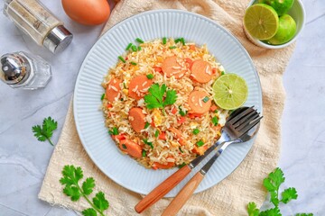 Sausage Fried Rice with carrot and eggs and sprinkle with vegetables on white plate , home made ,...