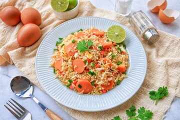 Sausage Fried Rice with carrot and eggs and sprinkle with vegetables on white plate , home made ,