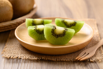 Sliced green kiwi fruit on wooden plate ready to eating, Healthy fruit