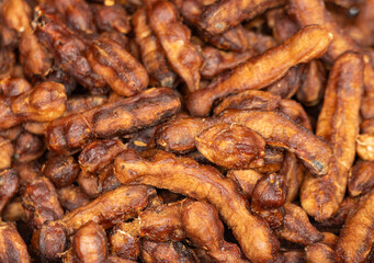 peeled tamarind fruits as background.