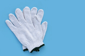 White cotton gloves on blue background.