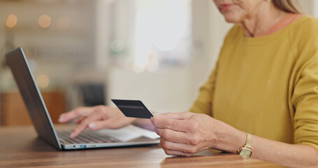 Fototapeta premium Credit card, hands or woman banking on laptop, internet or web for mortgage, bills or payment in home. Senior, ecommerce or closeup of person for online shopping deal or investment planning research