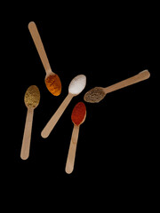 Various asian spices in Spoon on Black background