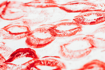 Imprint of red lips on white paper, kiss background
