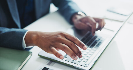 Businessman, hands and typing with laptop for accounting, email or finance on desk at office. Closeup of African employee, accountant or investor working on computer for financial budget or report